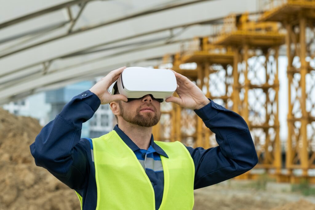 Serious builder in uniform and vr headset